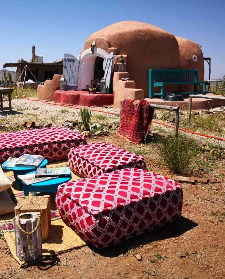 Camel ride through the scenic landscapes of Sidi Bouatman with a view of the captivating museum, ancient cisterns, and a stunning sunset in Marrakech.